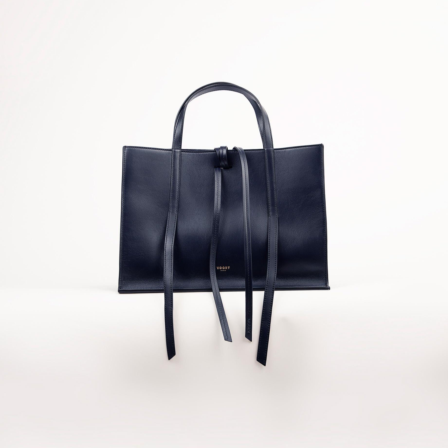 Blue Black handbag with straps on a white background